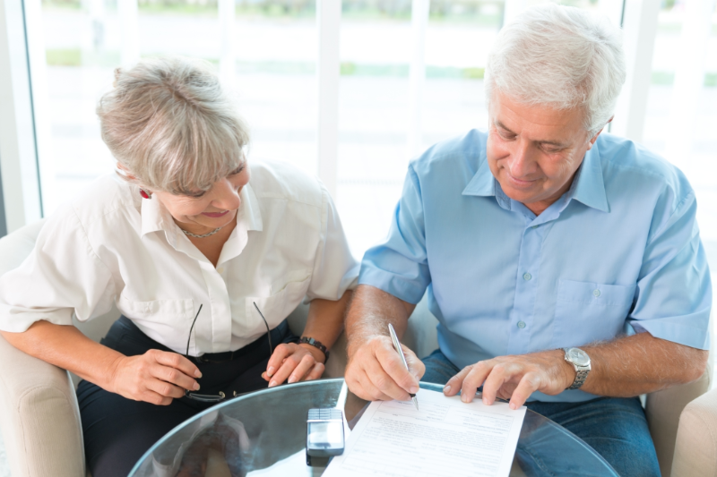 Dona Jeka and Couple signing reverse mortgage papers